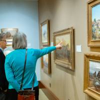 Guests admiring paintings at Friends of Alten 2018